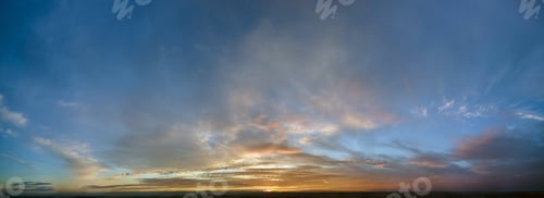Preview: Bright colorful sunset sky with vivid smooth clouds illuminated with setting sun