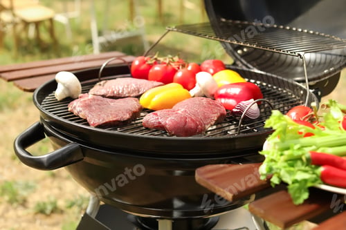 Preview: Modern grill with meat and vegetables outdoors, closeup