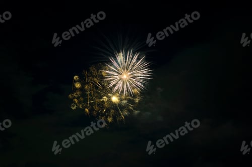 Preview: Aerial view of bright fireworks exploding with colorful lights against dark night sky