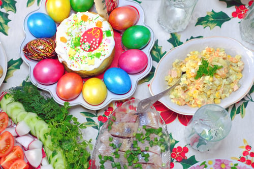 Preview: Ukrainian Easter festive dishes. Festive table setting. Bright colored eggs, cake Paska
