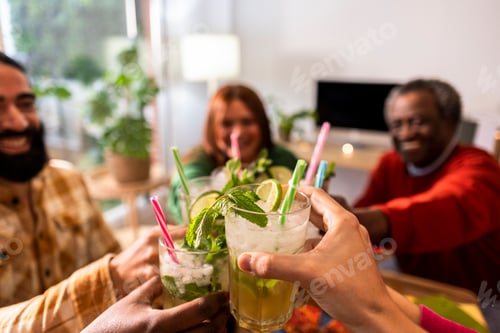 Preview: Group of multiethnic friends drinking and toasting with glasses of mojito