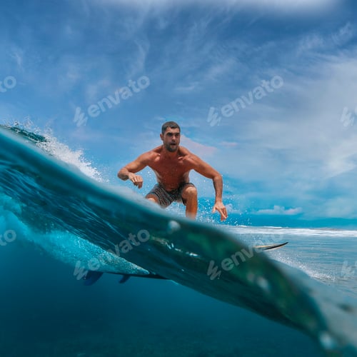 Preview: Shirtless male surfer on a wave at sunny day