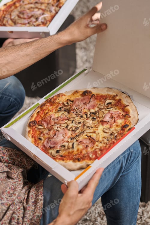 Preview: Anonymous males eating pizza in living room