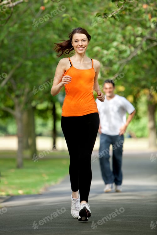 Preview: Beautiful Fit Woman Jogging Outdoors And Smiling