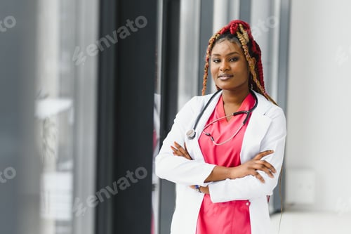 Preview: Portrait of female African American doctor standing in her office at clinic.