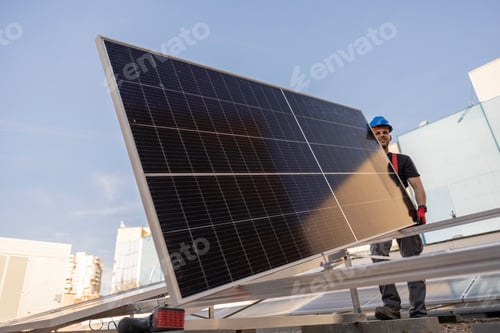 Preview: Man worker installing solar photovoltaic panels on roof, alternative energy concept.