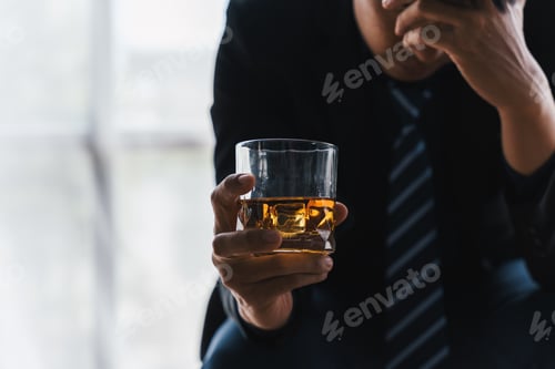 Preview: drunk asian man hold whisky glass addicted alcohol need therapy.