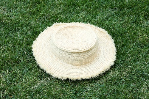 Preview: Straw hat on green grass outdoor in summer day