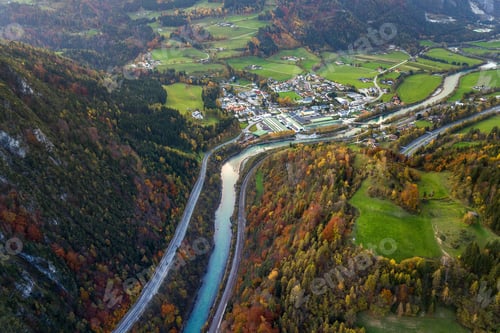 Preview: Aerial view of green meadows with villages and forest in austrian Alps mountains.