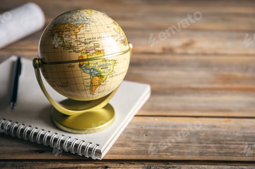 Preview: Travel composition with earth globe and notepad on blurred background.