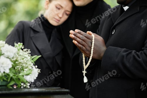 Preview: Hands in prayer holding rosary