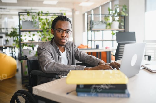 Preview: African american student using laptop in modern office