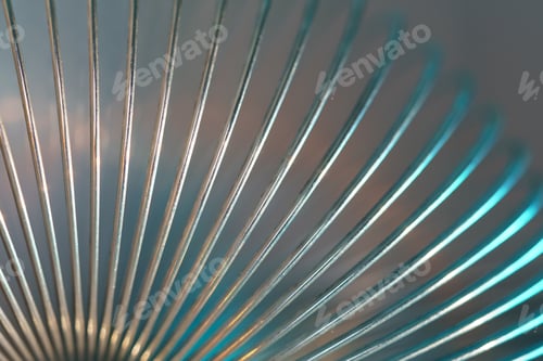 Preview: Closeup of coiled metal spring with sufficiently high strength and elastic properties in neon light