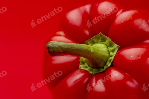 Preview: Red on radiant red of paprika pepper with green stem