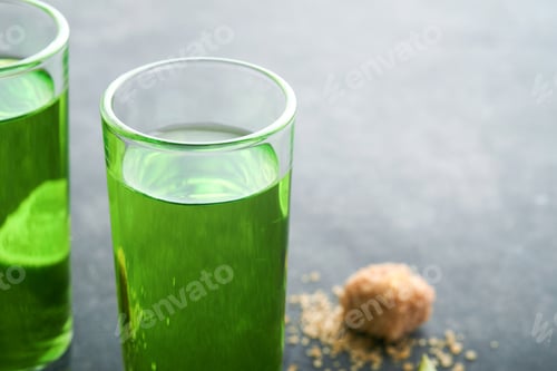 Preview: Absinthe. Two glasses of absinthe with cane sugar and lime on dark background. Strong alcoholic drin