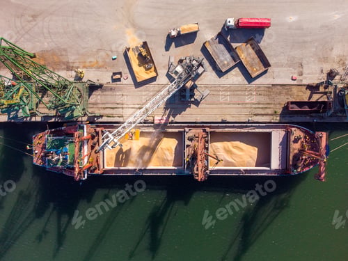 Preview: cargo ship loading in port at sunset