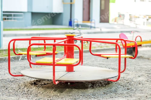 Preview: Red carousel on the playground in the city. The concept of childhood, parenting, games.