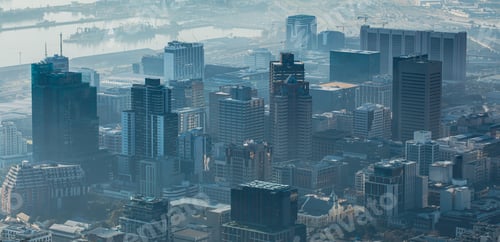 Preview: General view of cityscape with multiple modern buildings and skyscrapers in the foggy morning