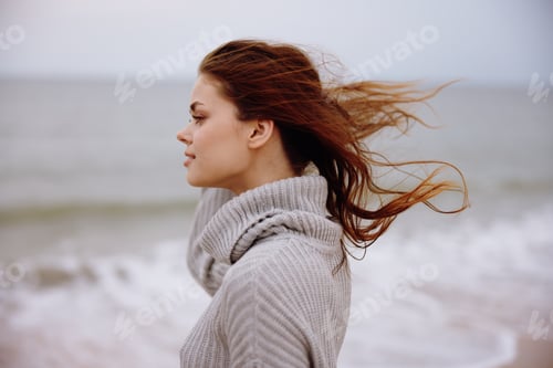 Preview: portrait of a woman alone by the ocean cloudy weather Lifestyle