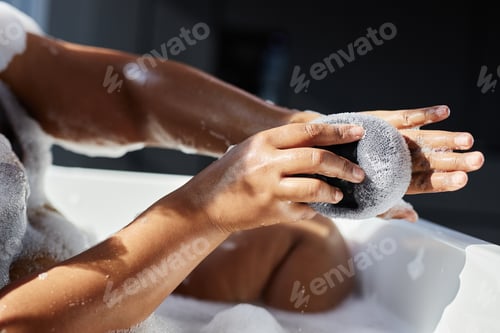 Preview: Hands of Black Woman Massaging Skin with Bath Sponge Indoors