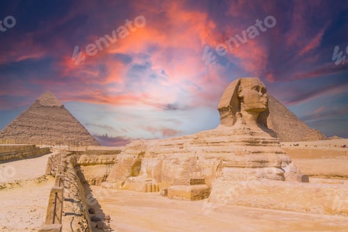 Preview: View of the the Great Sphinx and the Pyramids of Giza against a colorful sunset at Giza, Egypt