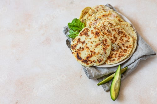 Preview: Homemade chapati or roti flatbread with salad mix, avocado and sprouts. Baked Indian flatbread
