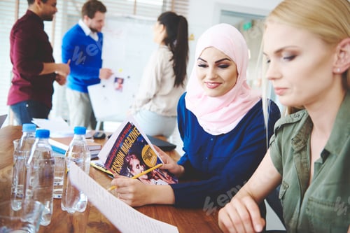 Preview: Two business women doing expertise of magazine