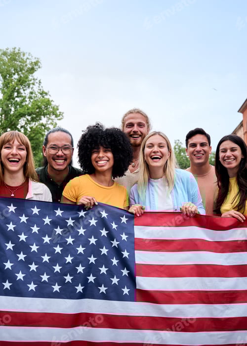 Preview: Multiracial group of friends holding American flag with pride, celebrating Independence Day outdoors