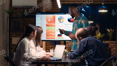 Preview: African american employee giving analytics presentation in business meeting