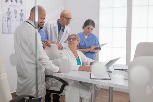 Preview: Physician hospital teamwork discussing disease expertise examining sickness diagnosis