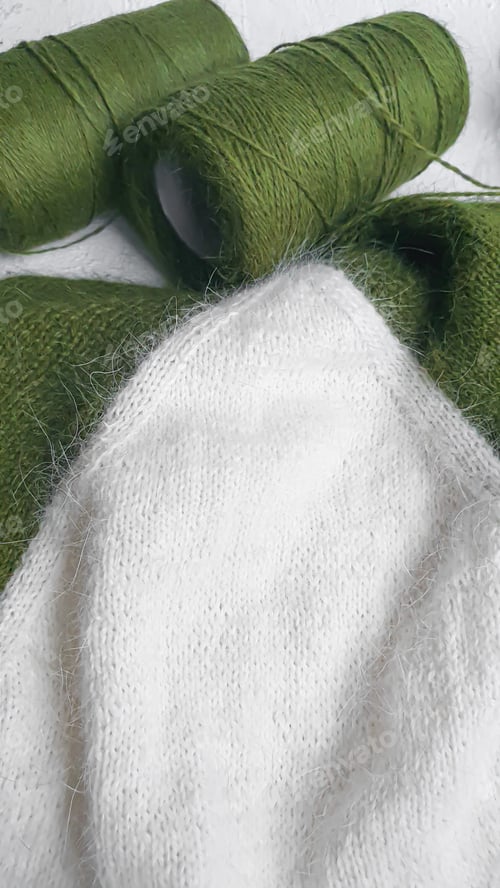 Preview: Handmade sweater. Knitted fabric from mink thread. White and olive color pattern.