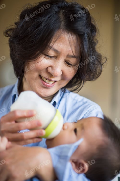 Preview: Grandmother feeding milk to grandson