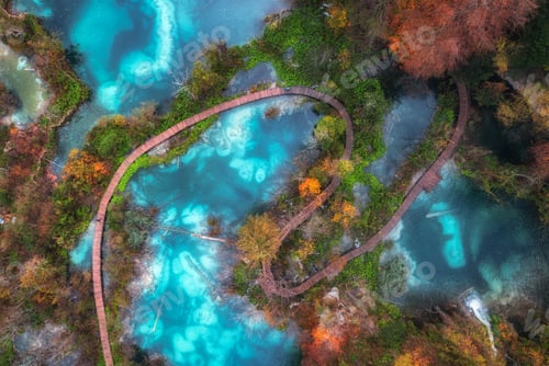 Preview: Aerial view of blue lakes in red autumn forest at sunrise