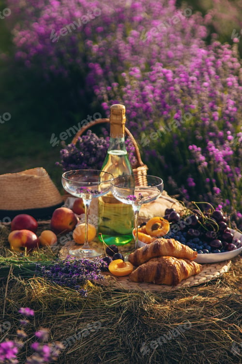 Preview: Picnic with wine in a lavender field. Selective focus.