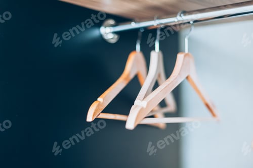 Preview: Wooden Clothes Hangers Hanging in Closet Interior