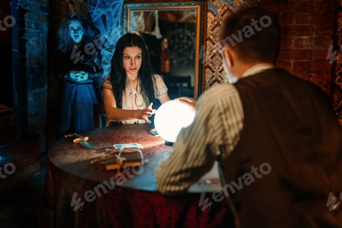 Preview: Couple on spiritual seance, witch on background