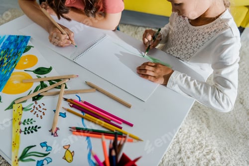 Preview: overhead view of babysitter drawing with cute kid in living room