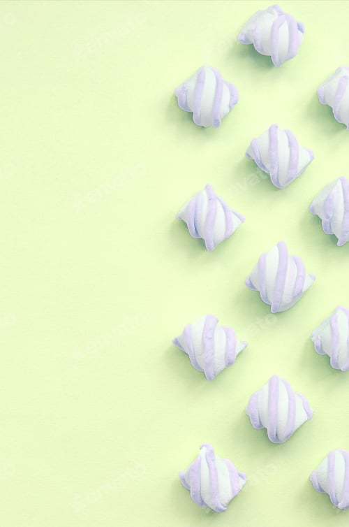 Preview: Colorful marshmallow laid out on lime paper background. pastel creative textures