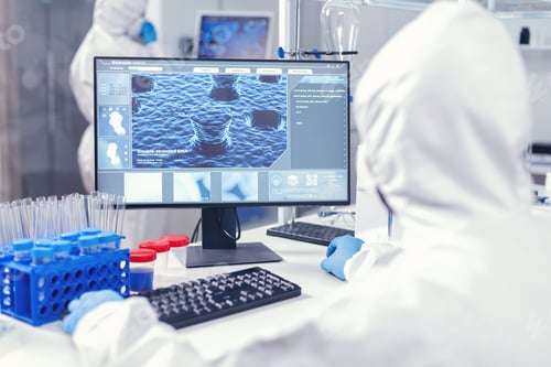 Preview: Over the shoulder shot of scientist monitoring and working with coronavirus