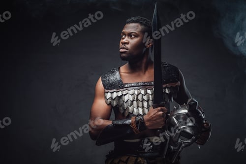 Preview: Authentic roman gladiator stares to camera on gray background