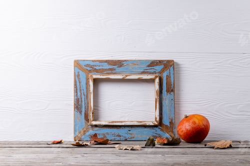 Preview: Composition of pumpkin with autumn leaves and frame with copy space on white background