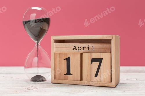 Preview: wooden cube shape calendar for april 17 on wooden tabletop