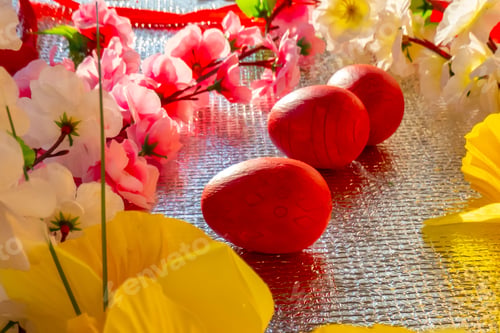 Preview: Bright Easter silver background decorated with ribbons of flowers and red eggs. A holiday card.