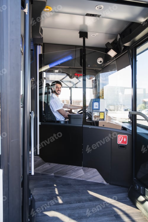 Preview: Bus driver smiling while operating public transport
