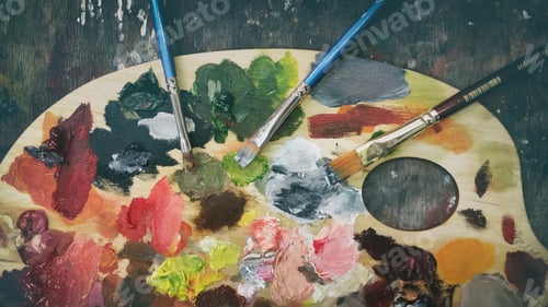 Preview: Paintbrushes and Colorful Paint on Wooden Palette
