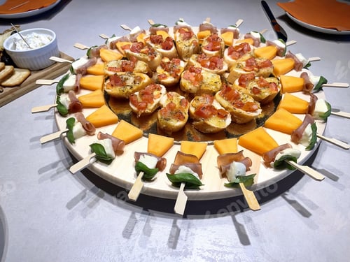 Preview: High angle view of decorated plate with bruschetta, cheese and processed meat