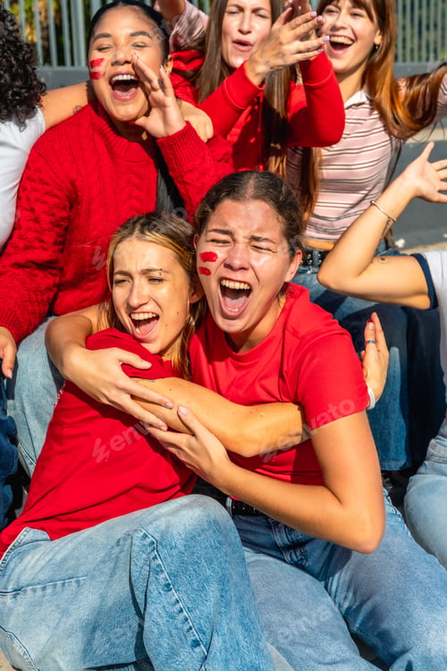Preview: Female sports fans cheering and celebrating with face paint