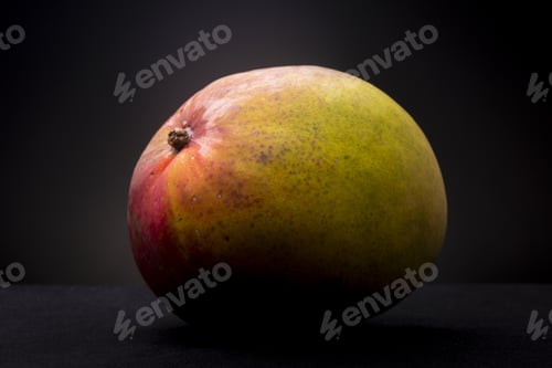 Preview: Low key still life of fresh colourful mango fruit