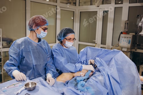 Preview: doctor and an assistant in the operating room for surgical venous vascular surgery clinic.