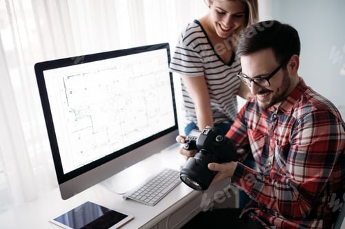 Preview: Young attractive designers working on project together